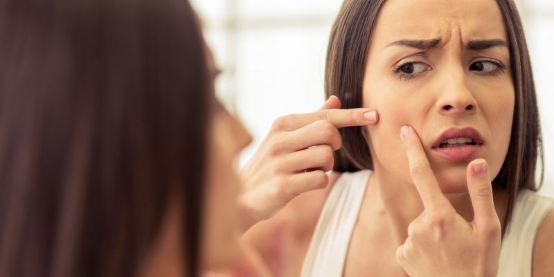 female face having acne